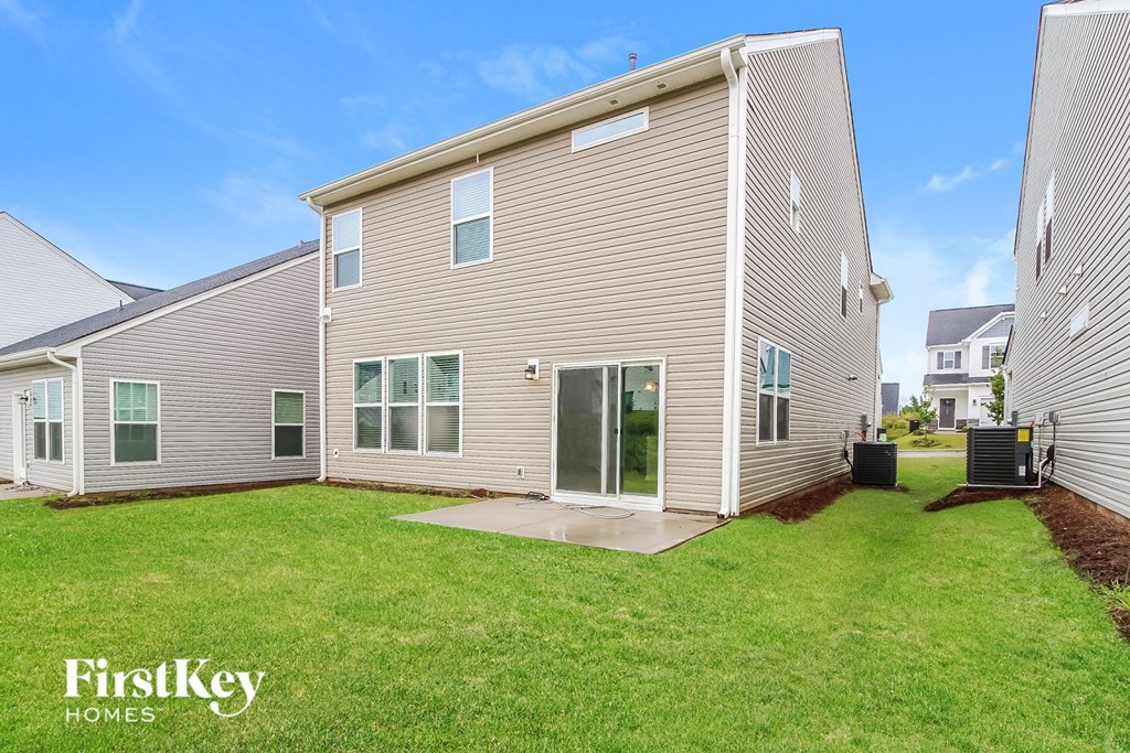 A FirstKey homes sign is displayed in front of a modern house.