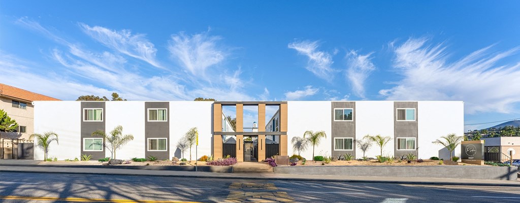 a large white building with a street in front of it