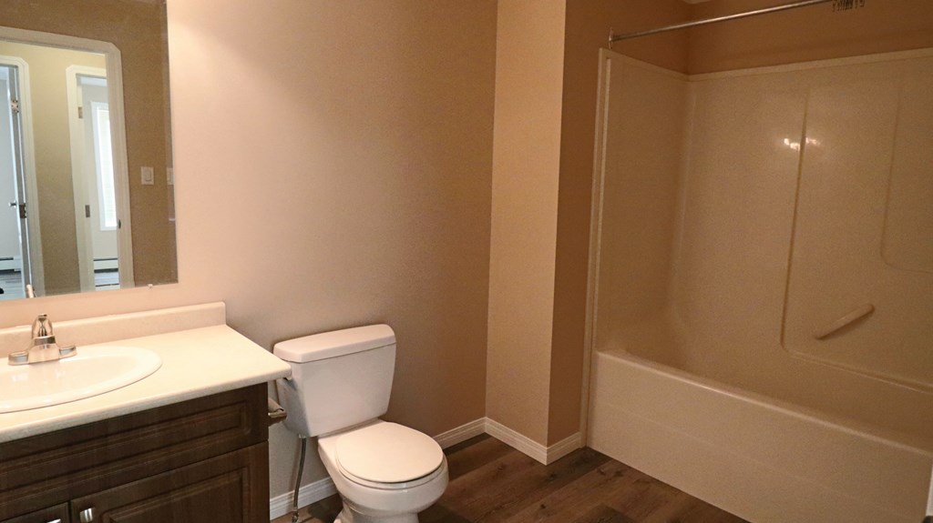 a bathroom with a toilet and a sink and a shower