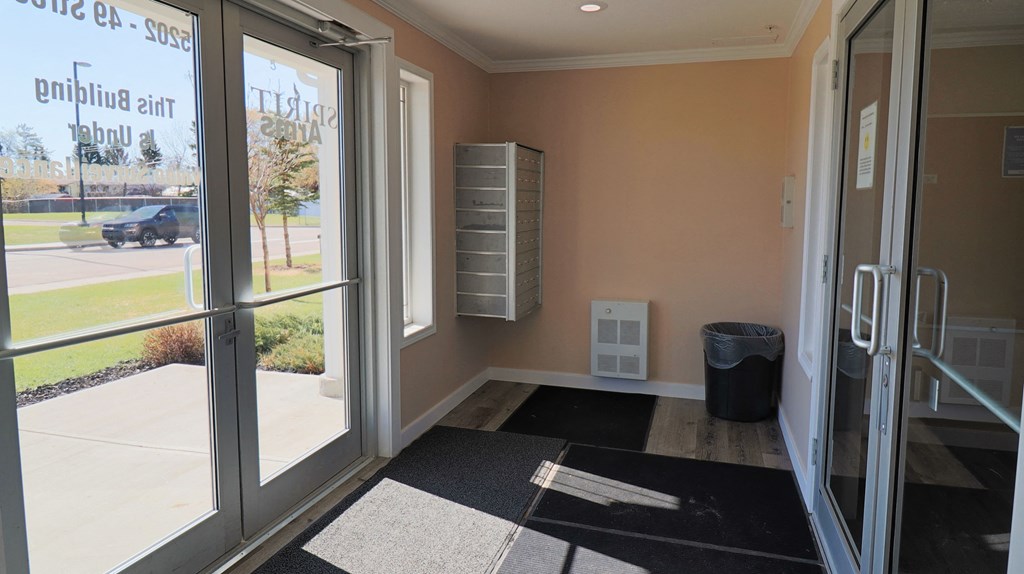 a entrance to a building with glass doors and a wheelchair ramp