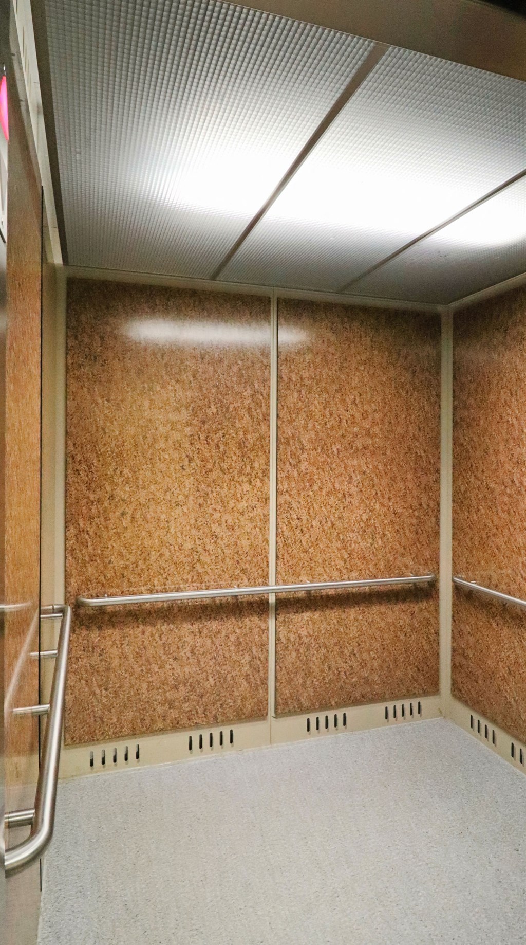 a large storage room with wood paneling on the wall