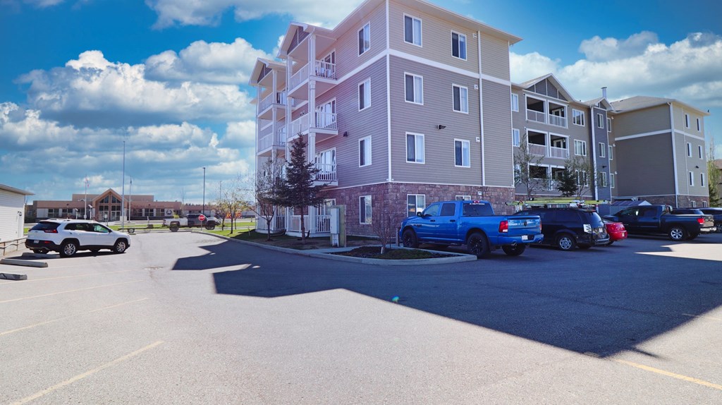 an apartment building with cars parked in front of it