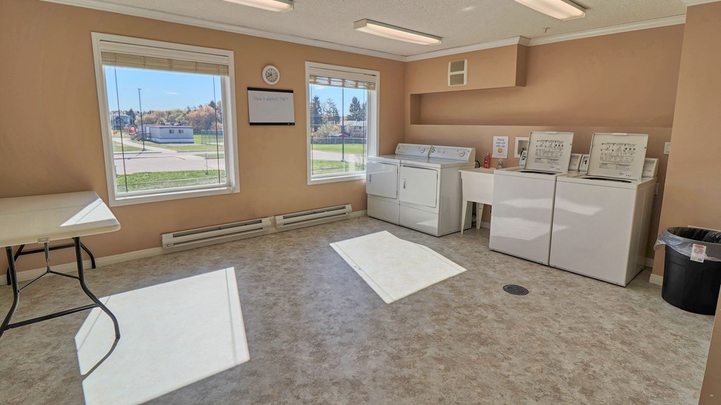 a laundry room with two washers and two sinks and two washing machines