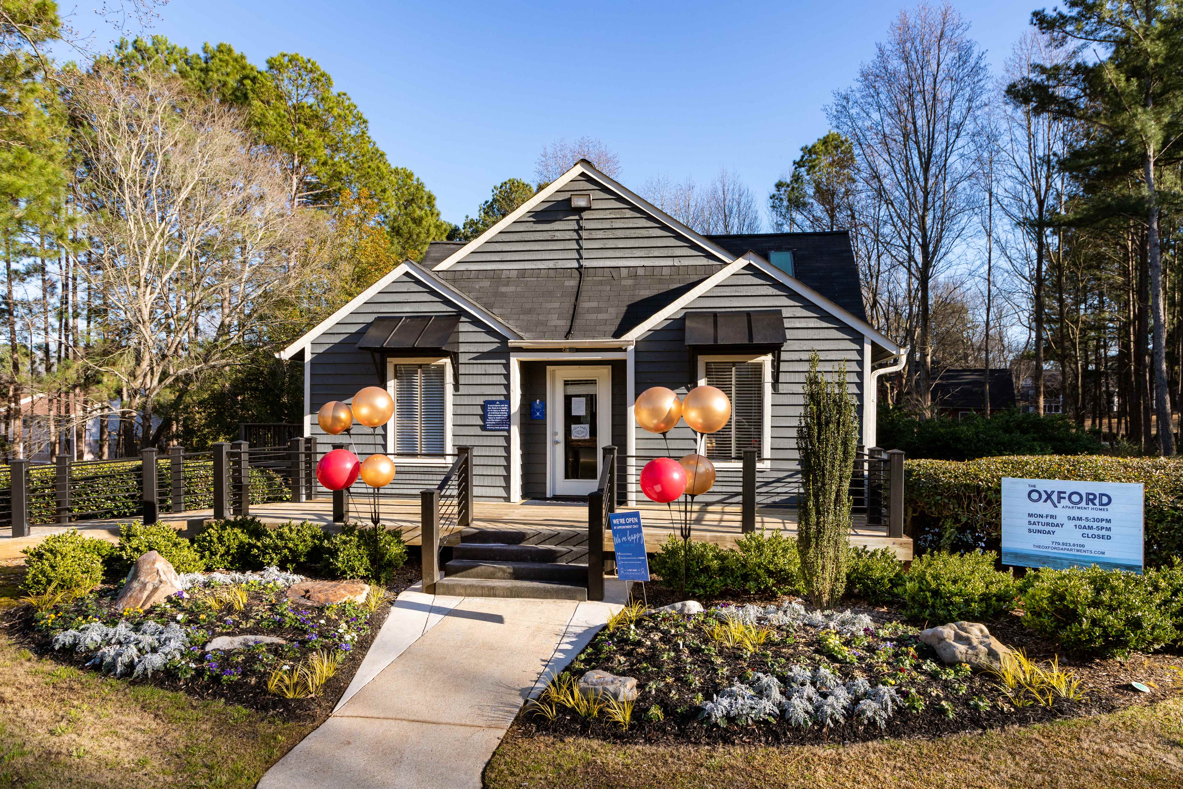 the front of a house with balloons in front of it