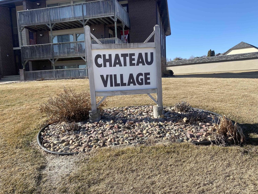 a sign for chateau village in front of a house