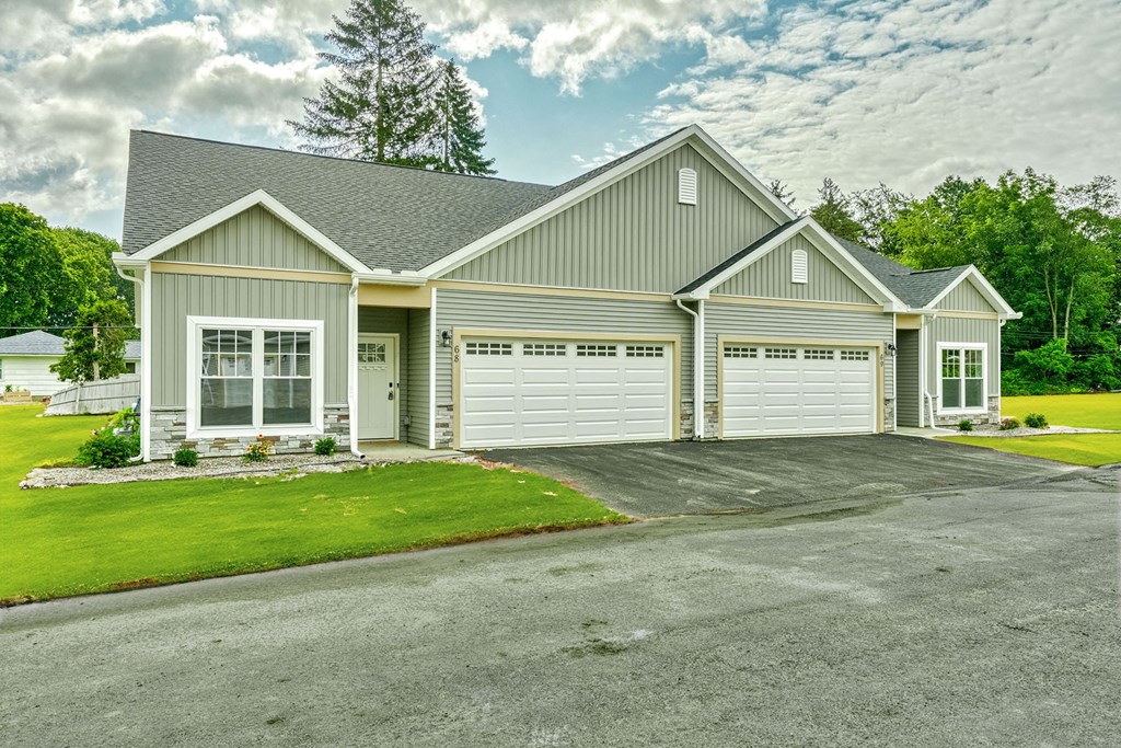 the front of a house with a garage and a driveway