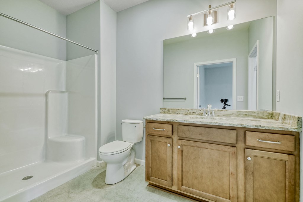 a bathroom with a sink toilet and a shower