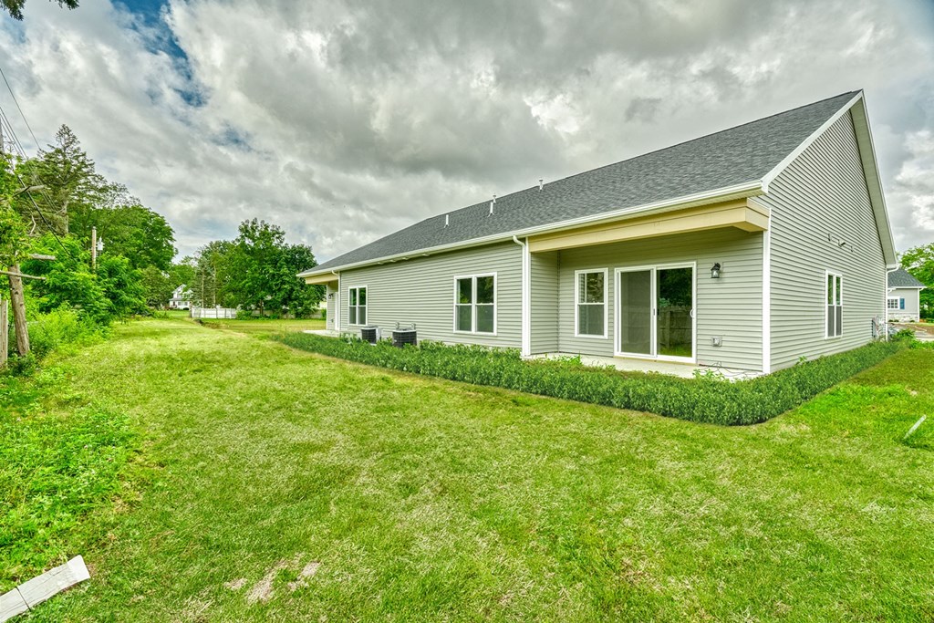 a white house with a yard in front of it
