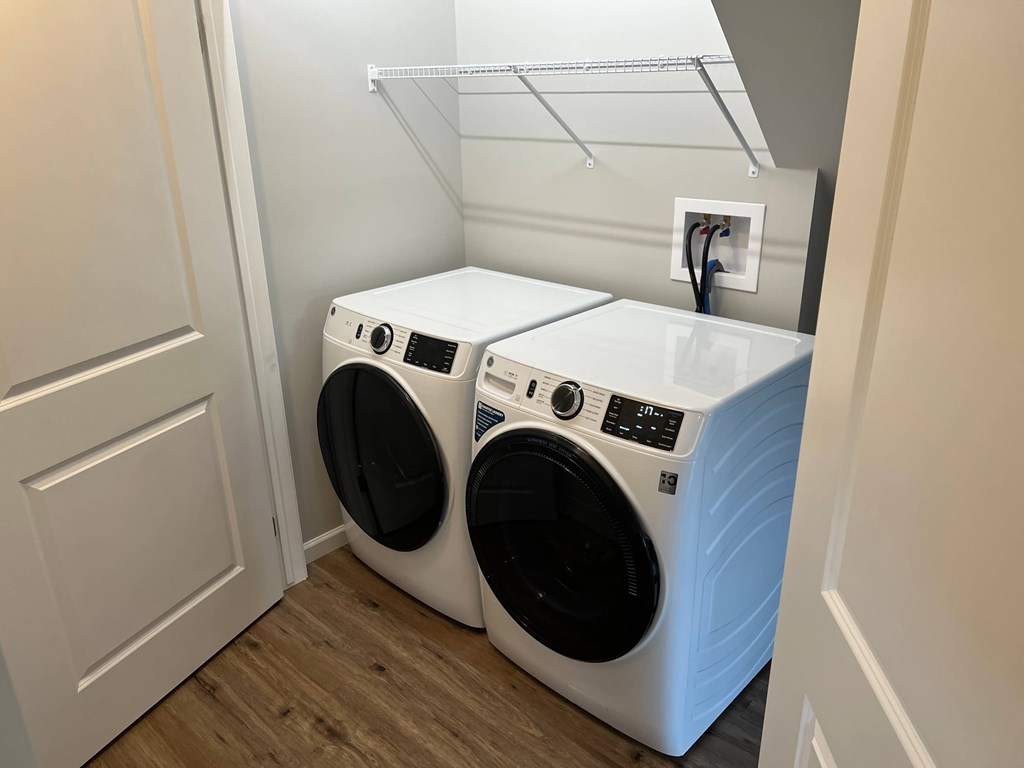 a washing machine and a dryer in a laundry room