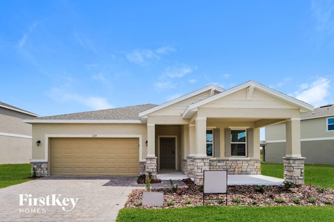 A house with a garage and a front porch is for sale.