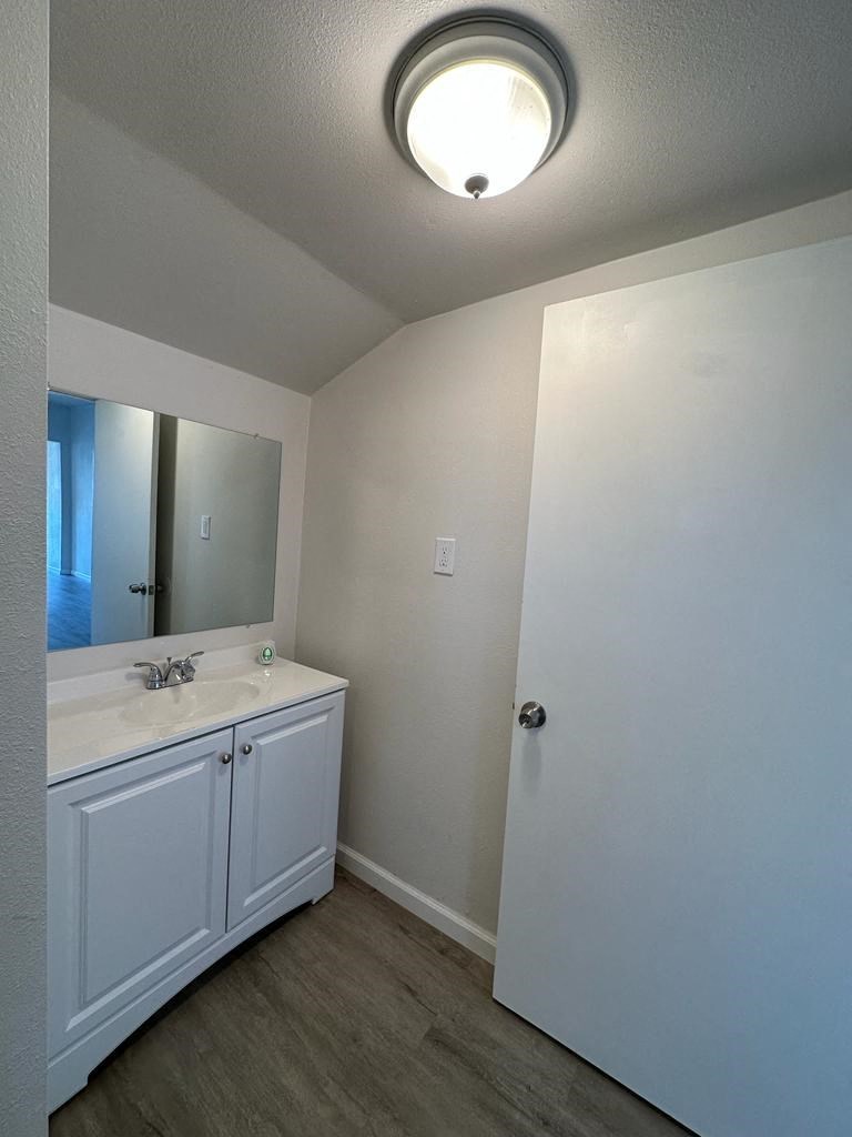 an empty bathroom with a sink and a mirror