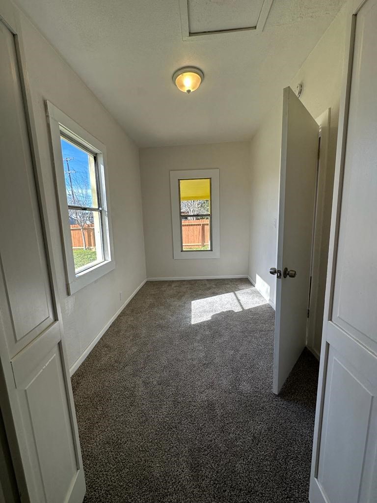 a empty room with a door and a window