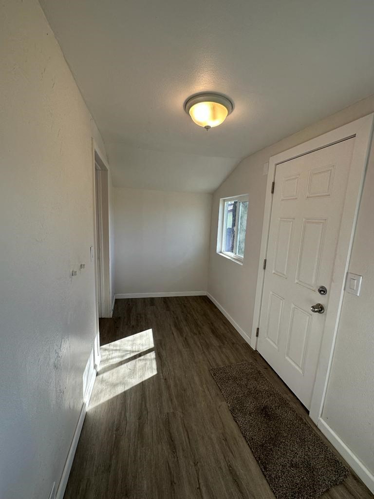 a hallway with a white door and a window