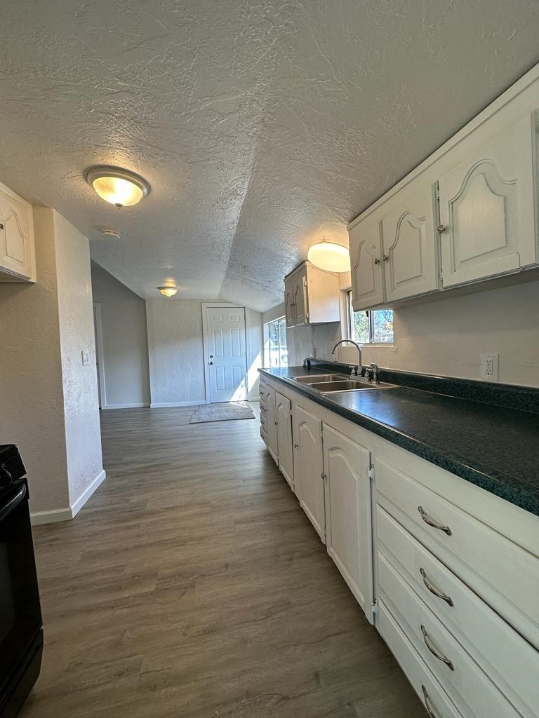 a kitchen with white cabinets and a counter top