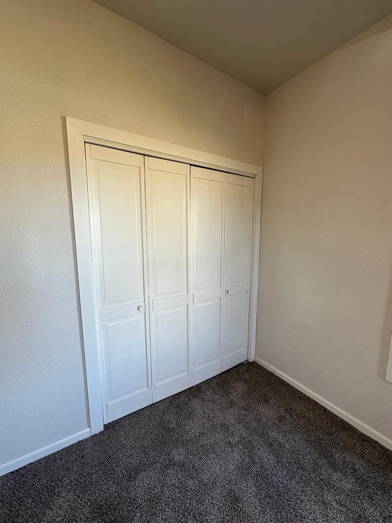 an empty room with three closets in it