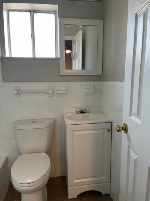 A white toilet and sink in a bathroom.