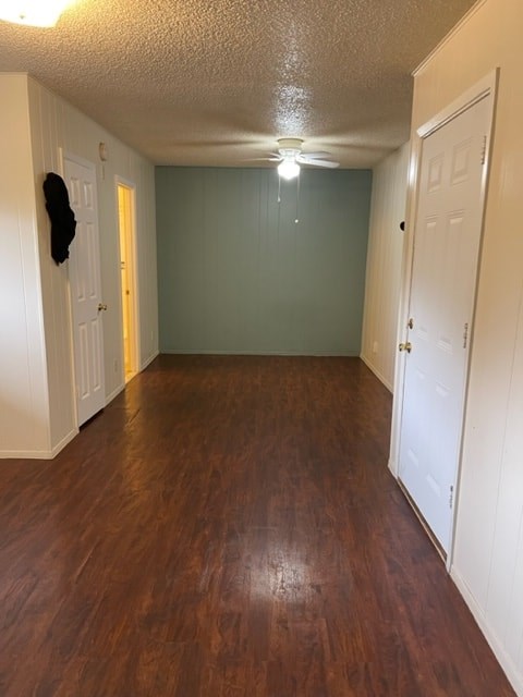 A hallway with wood floors and white doors.