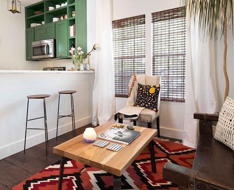 a small living room with a table and a kitchen