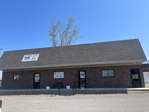 a brick building with two doors and a sign on the roof