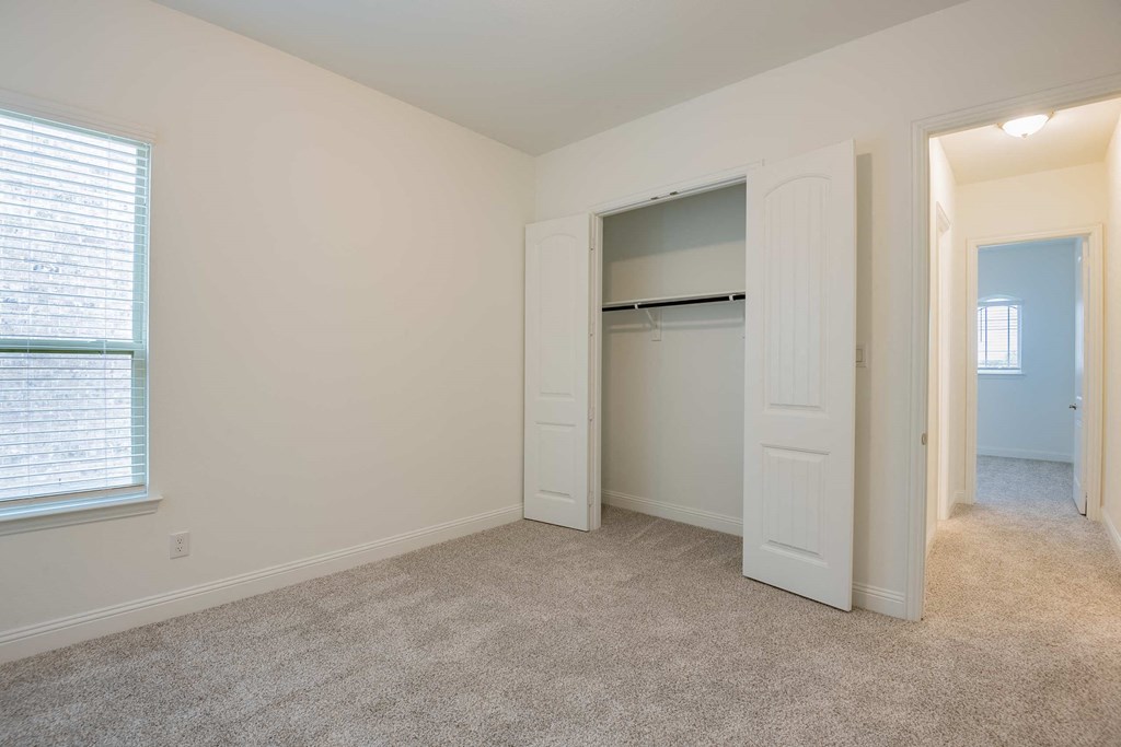 a bedroom with a closet and an open door
