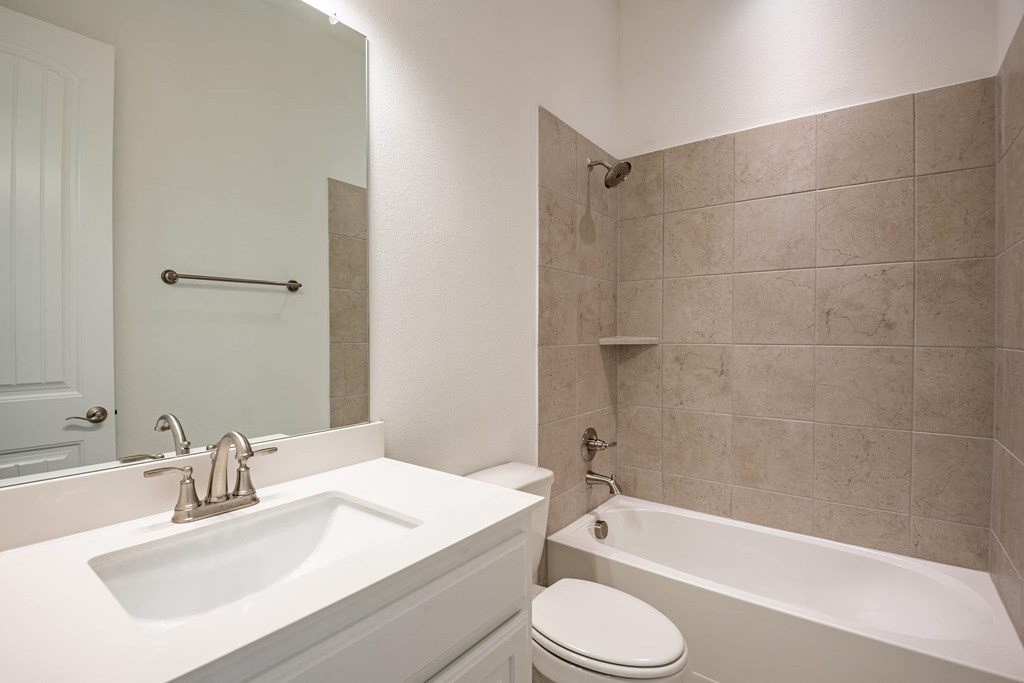 a bathroom with a sink toilet and a tub