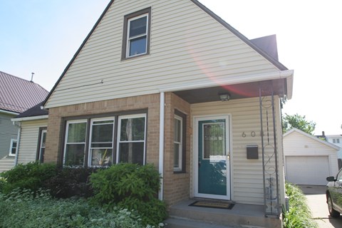 A house with a green door and a small porch.