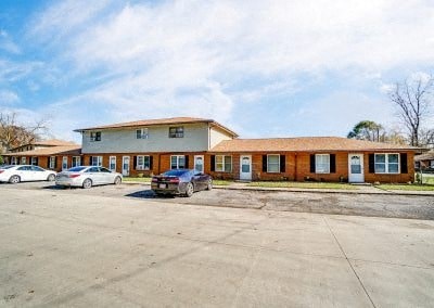 a large building with cars parked in a parking lot