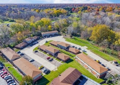 an aerial view of a group of buildings and a parking lot