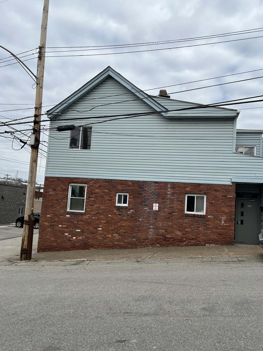 a red brick building with a blue house on the side