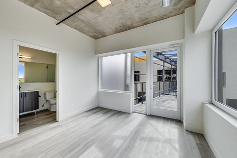 A room with a white door and a window.