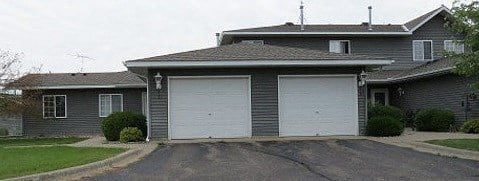 a house with two garage doors in front of it
