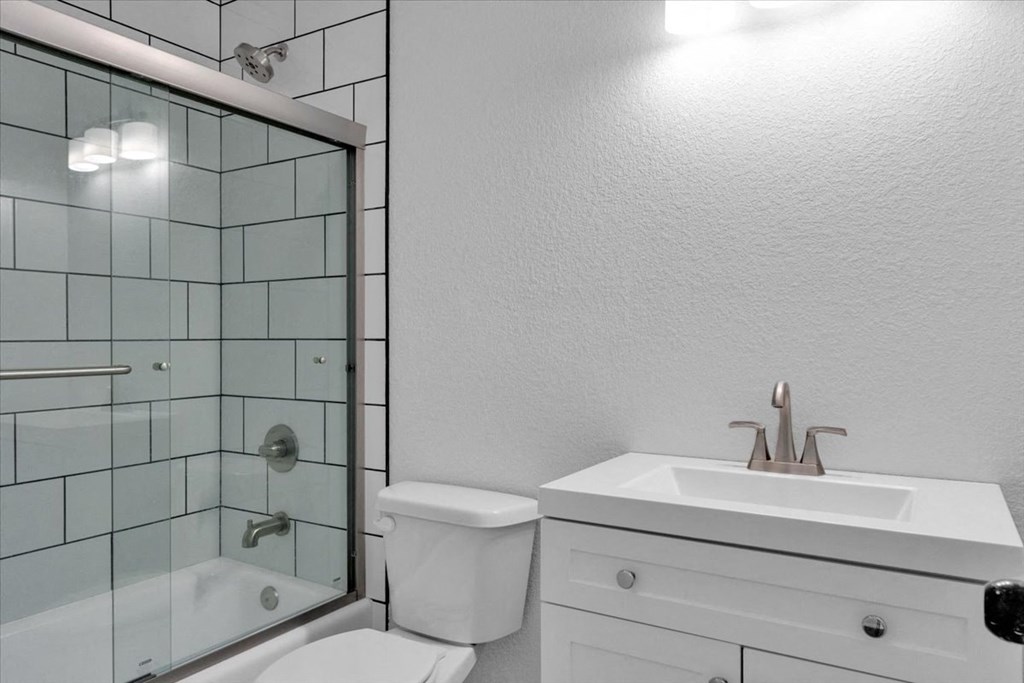 a bathroom with a sink toilet and a shower