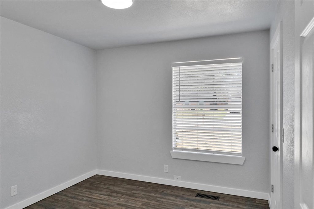 the living room of an empty house with a window