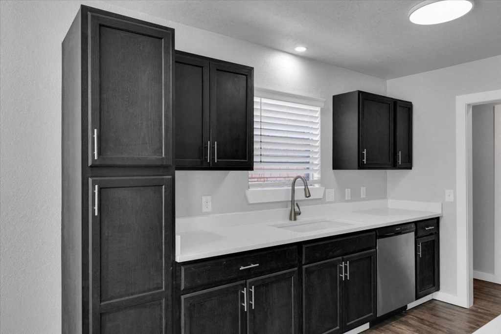 the kitchen of a new home with black cabinets