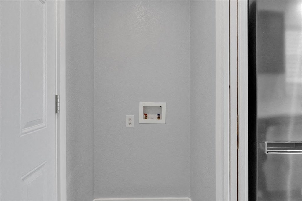 a white thermostat on a wall next to a door