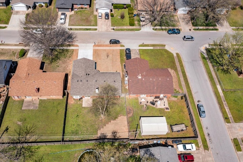 a view from above of a neighborhood with houses and a street