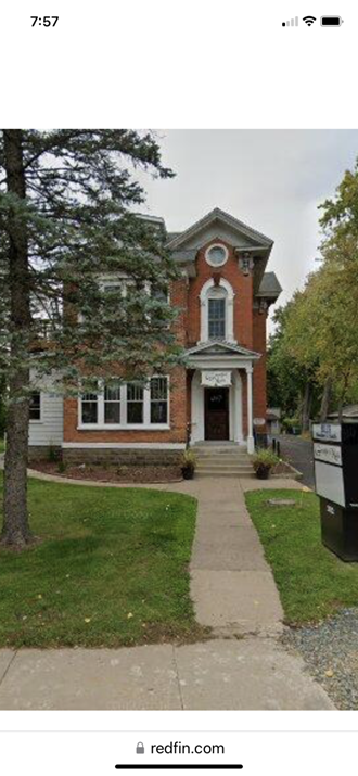 a house with a clock on the front of it