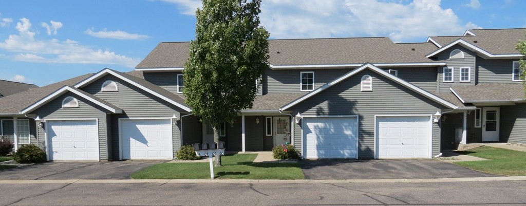 a house with two garage doors on a street