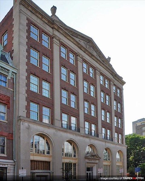 a tall brick building with a lot of windows