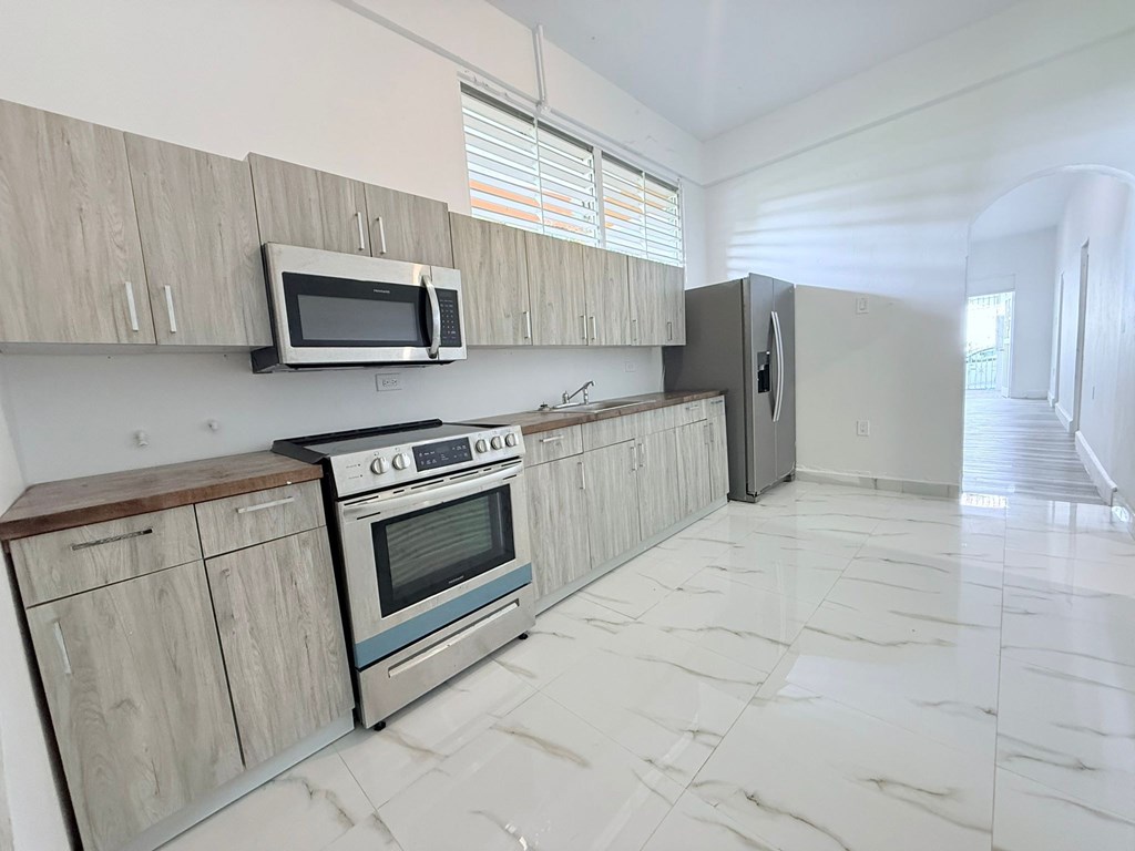 A kitchen with a stove, oven, and microwave.