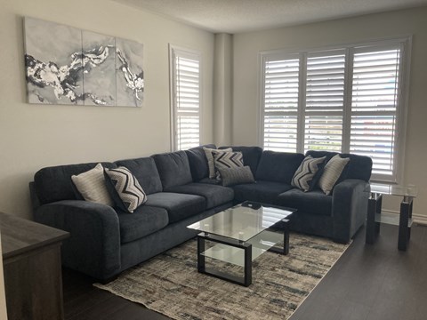 a living room with a blue couch and a coffee table