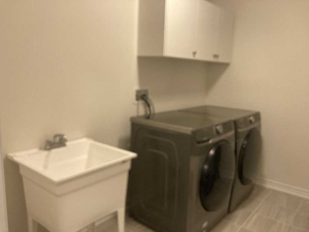 a bathroom with a washing machine and a sink