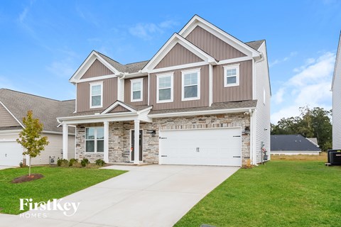 A two-story house with a garage is for sale.