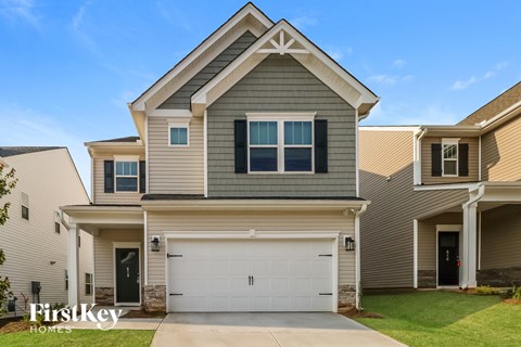 A two-story house with a garage is for sale.