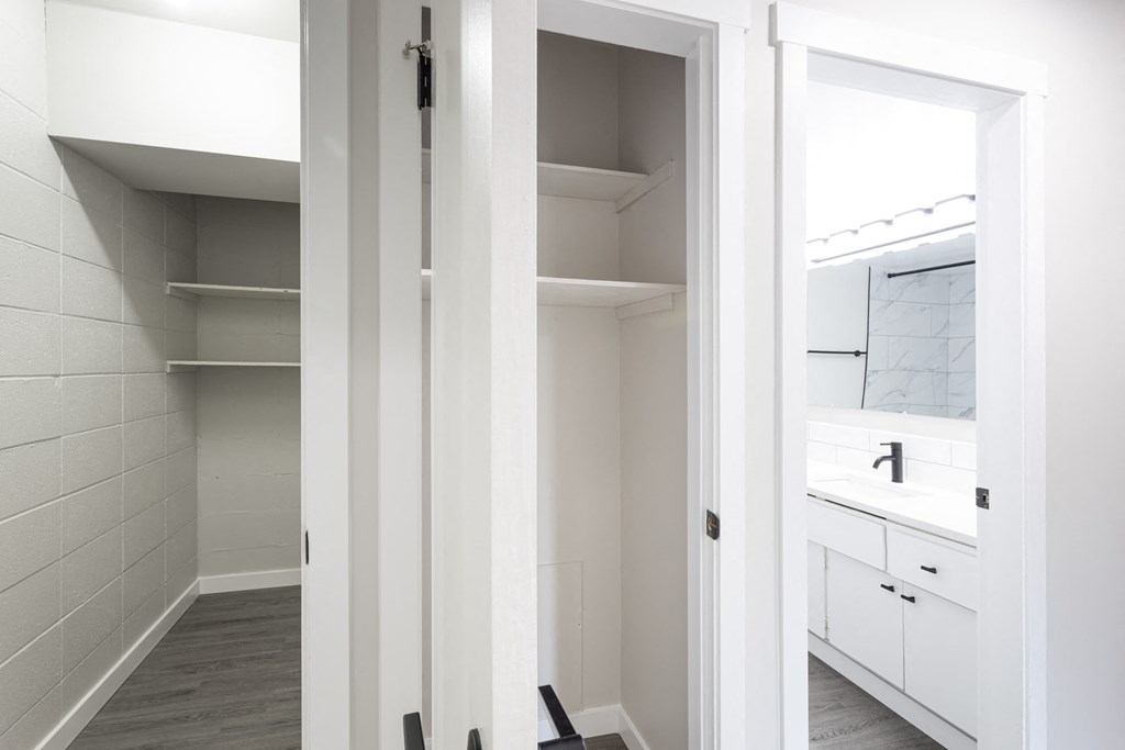 a small bathroom with a mirror and a closet