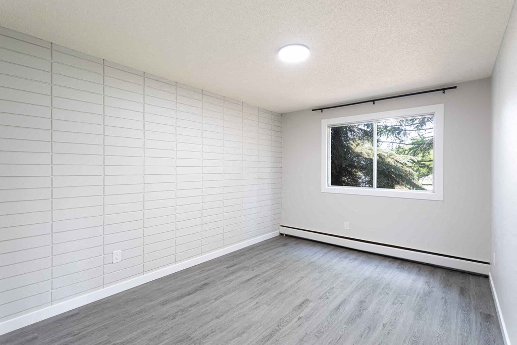 an empty room with white walls and a window