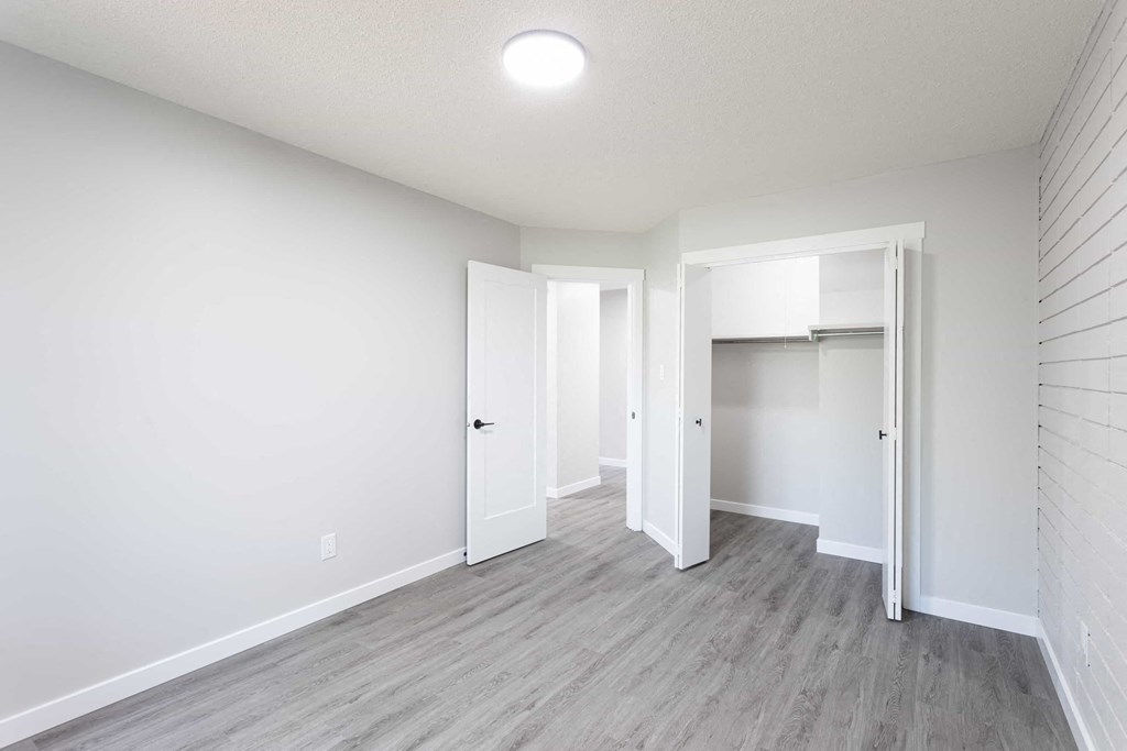a living room with white walls and wood floors