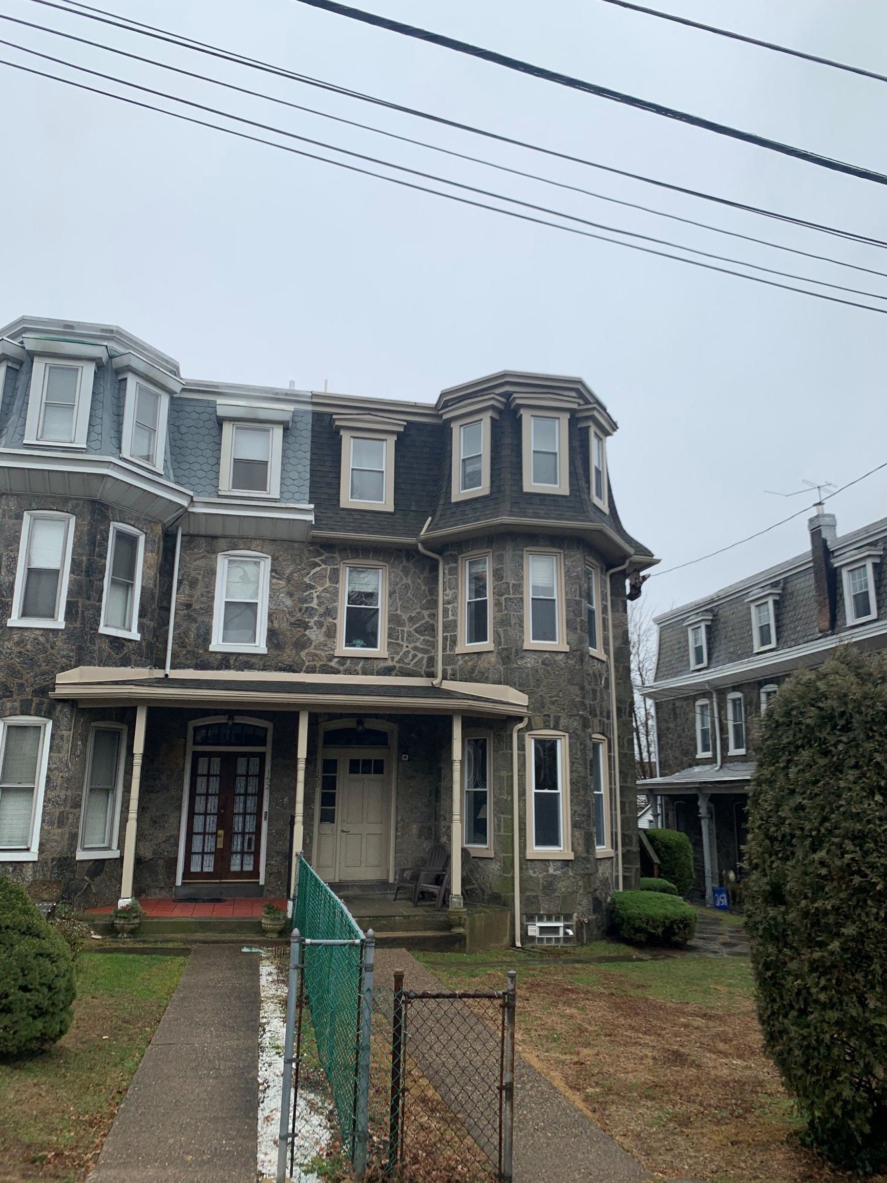 the front of an old house with a blue roof