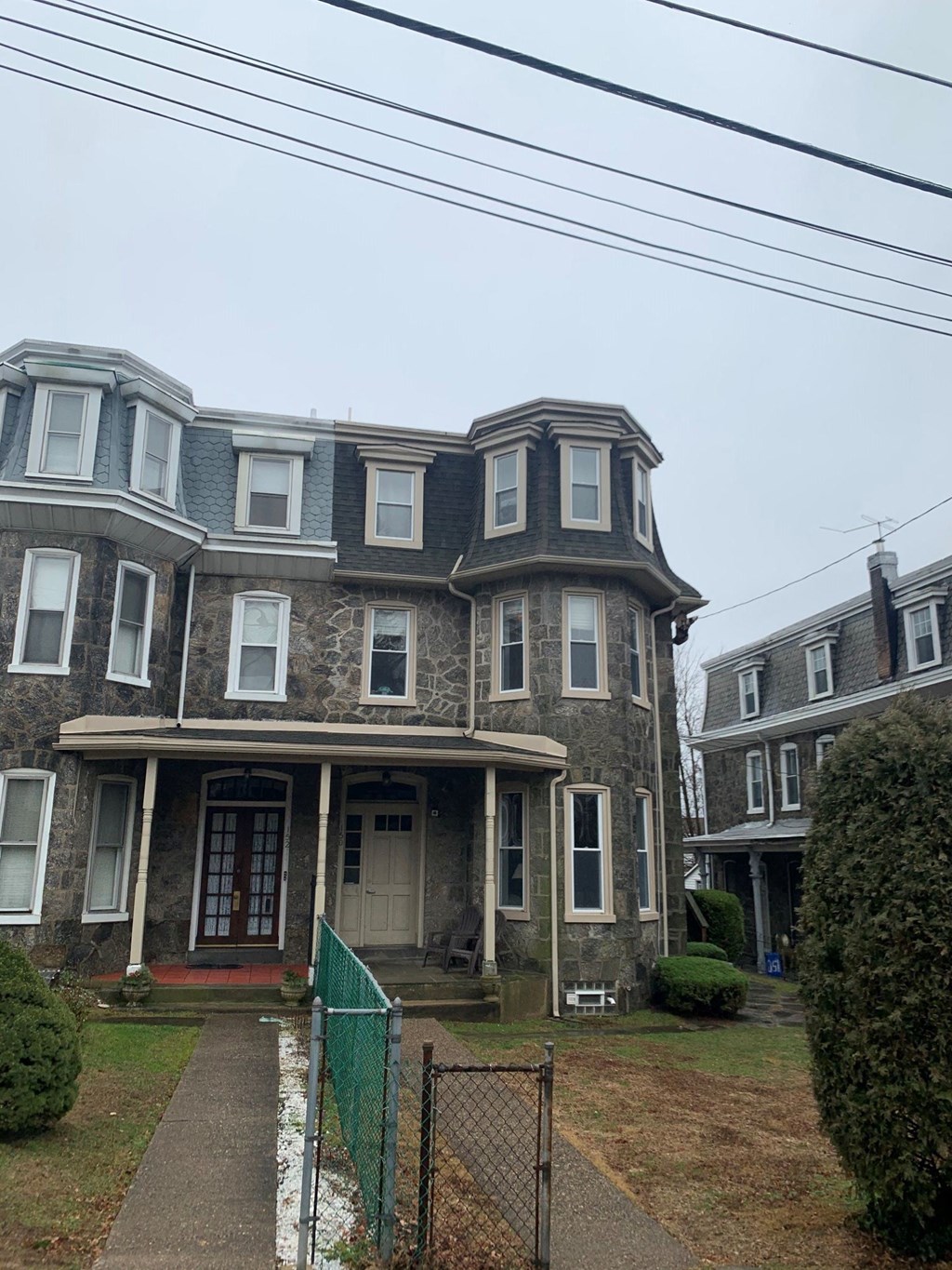 the front of an old house with a blue roof