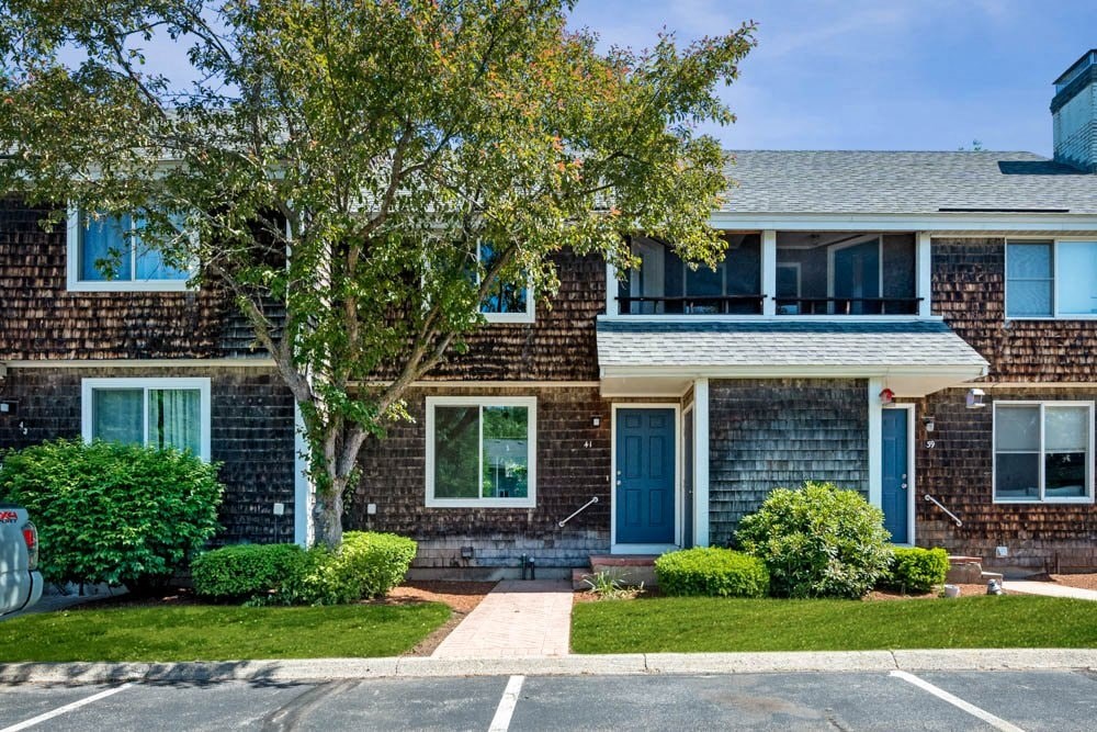 the front of a brick house with a blue door